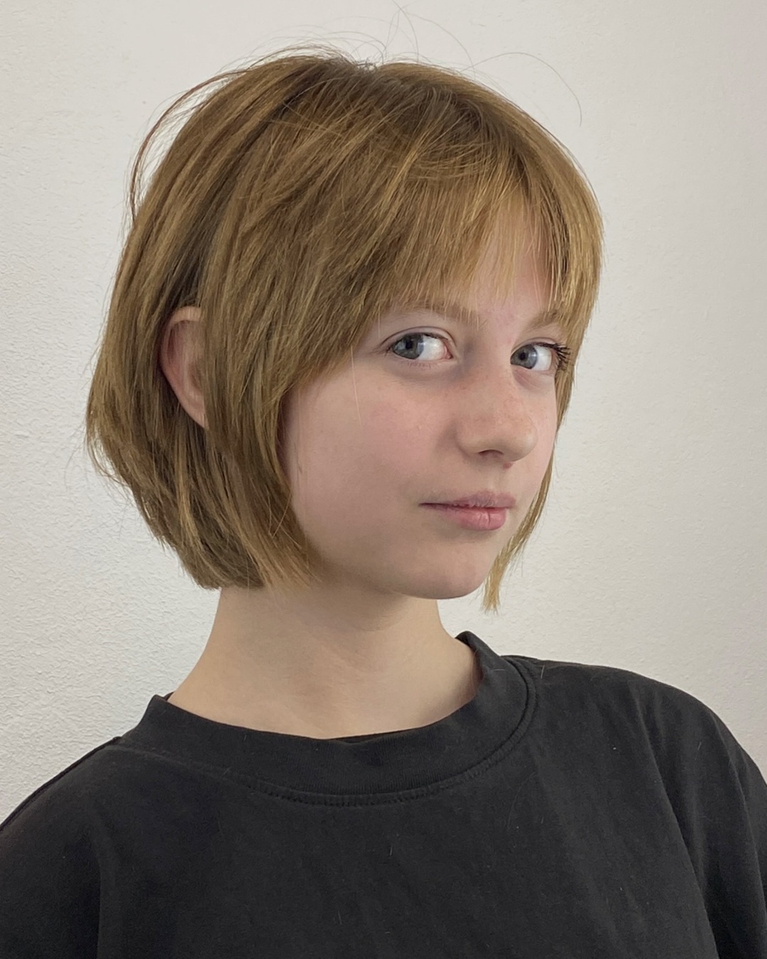 teen girl with light brown choppy bob and soft wispy bangs