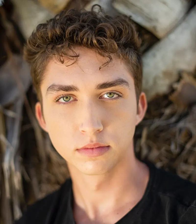 teenage boy with brown hair and green eyes