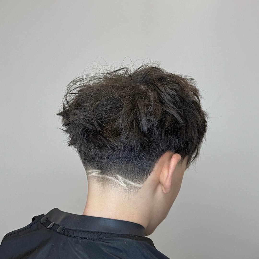 messy textured crop top with low taper fade and shaved nape line design