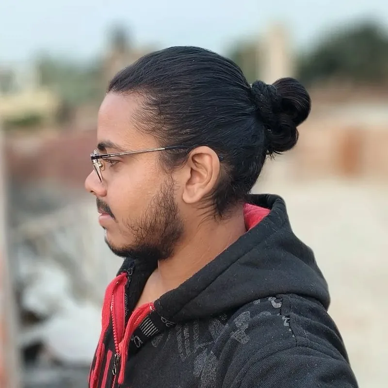 thick hair bun for man with glasses