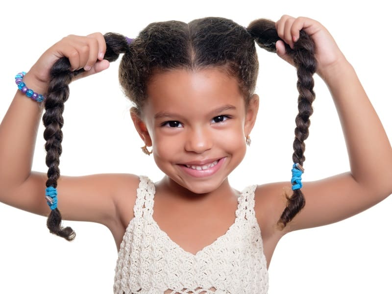 Image of Child with a shag haircut styled with pigtails