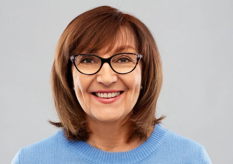 thick hairstyle for women over 60 with glasses