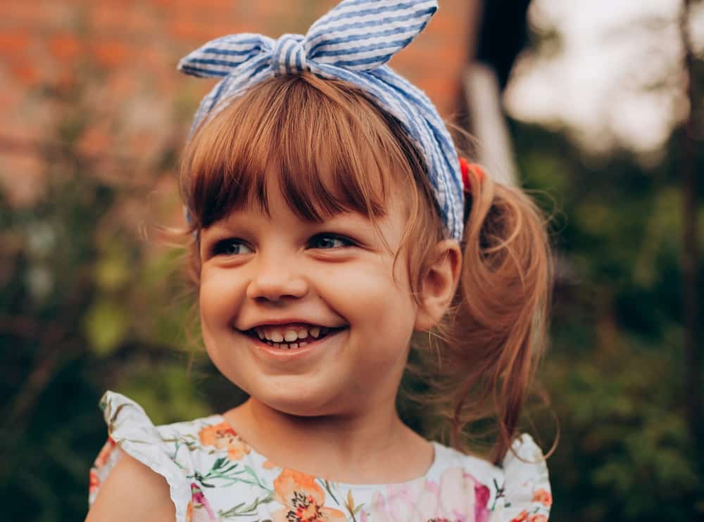 toddler girl with side ponytail