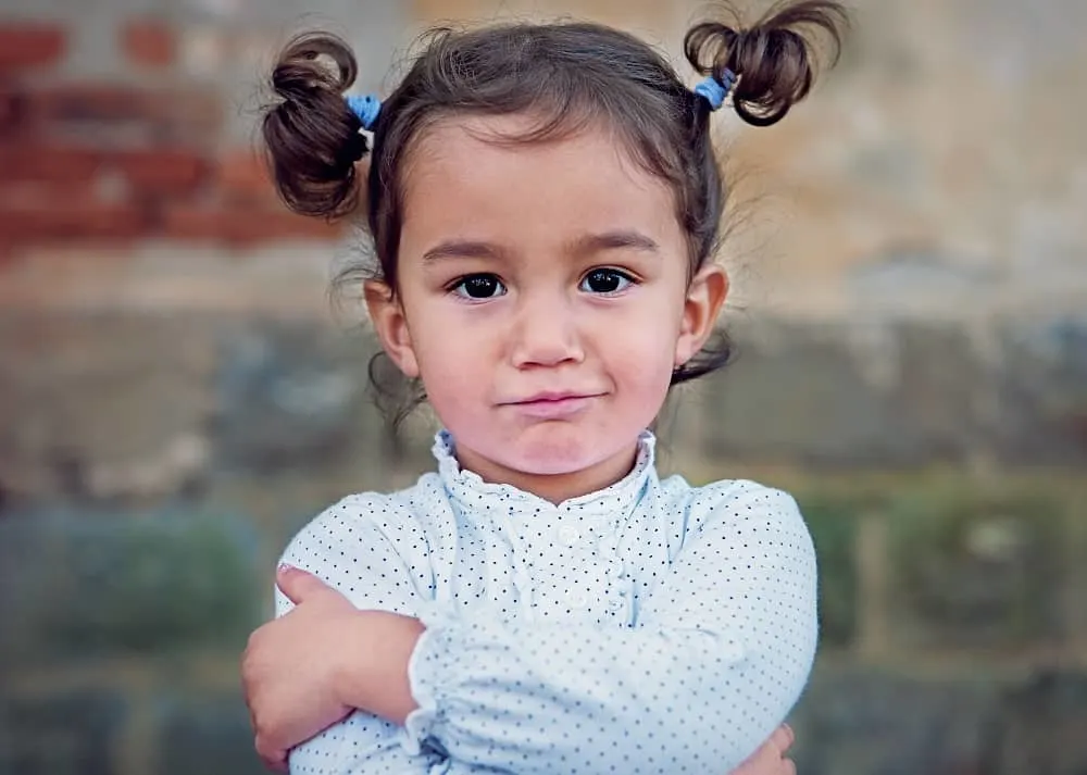 toddler girl with two ponytails