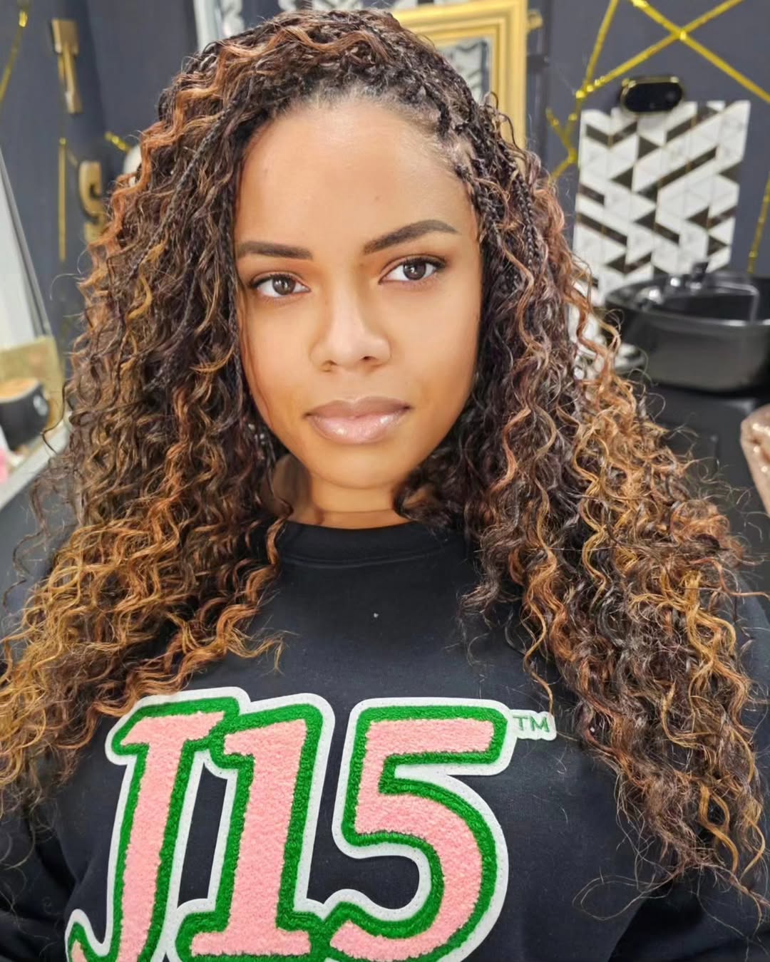 black woman with long loose curly tree braids