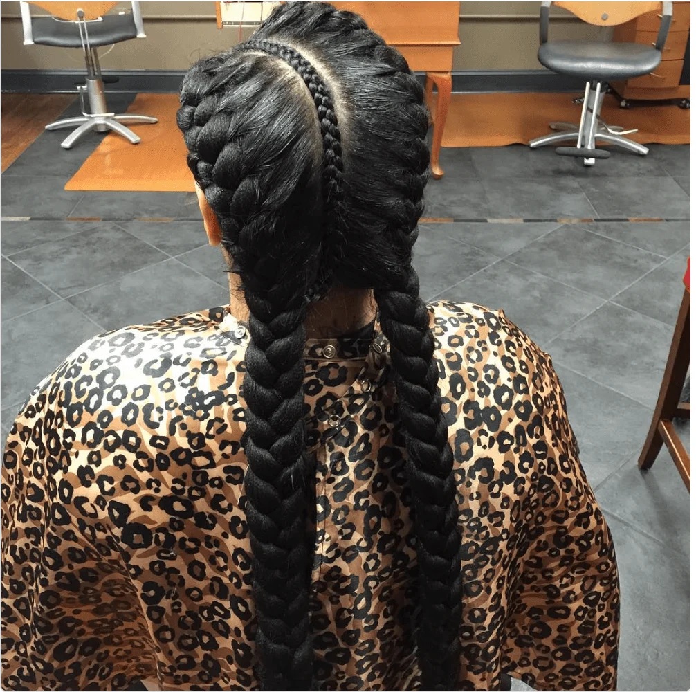 Back view of two thick, chunky pigtail braids with weave and a small accent braid