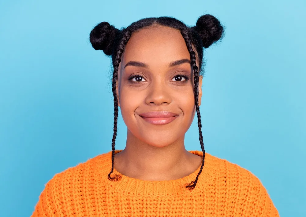 two natural hair buns with braids