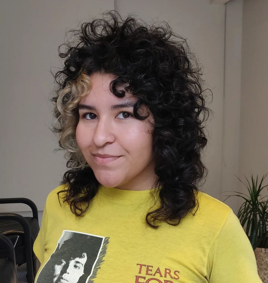 Curly hair in two shades with curtain bangs
