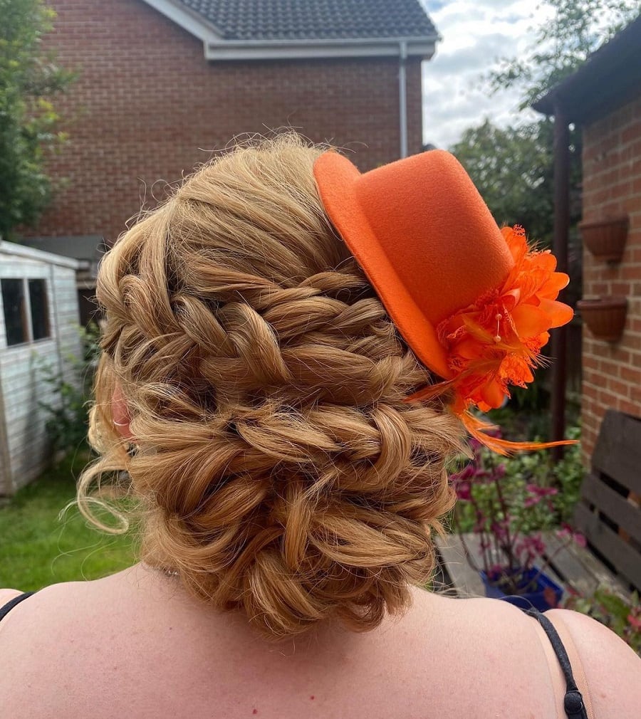 updo hairstyle with fascinator for mother of the brides
