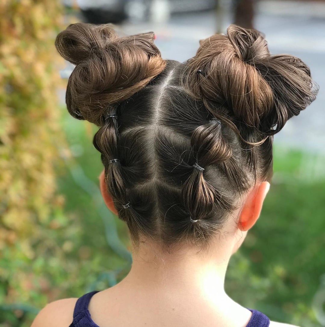 Brown hair styled with bubble braids along the scalp leading into high space buns
