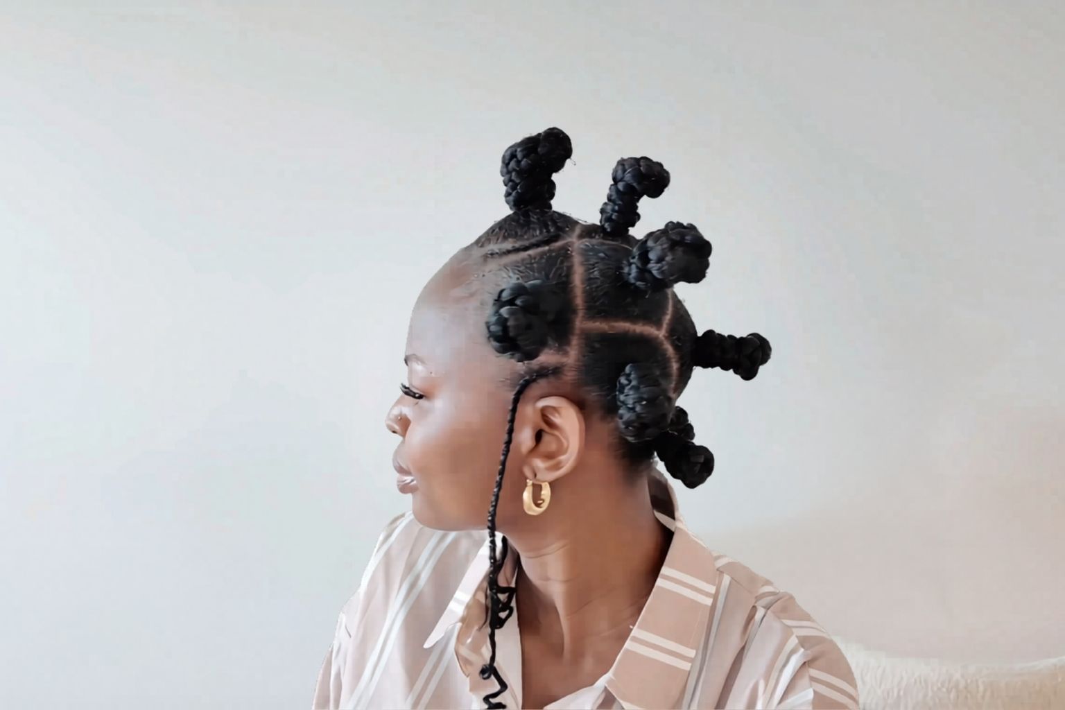 Recreated viral Bantu knot hairstyle with clean curved partings, raised knots, and a coiled side braid.