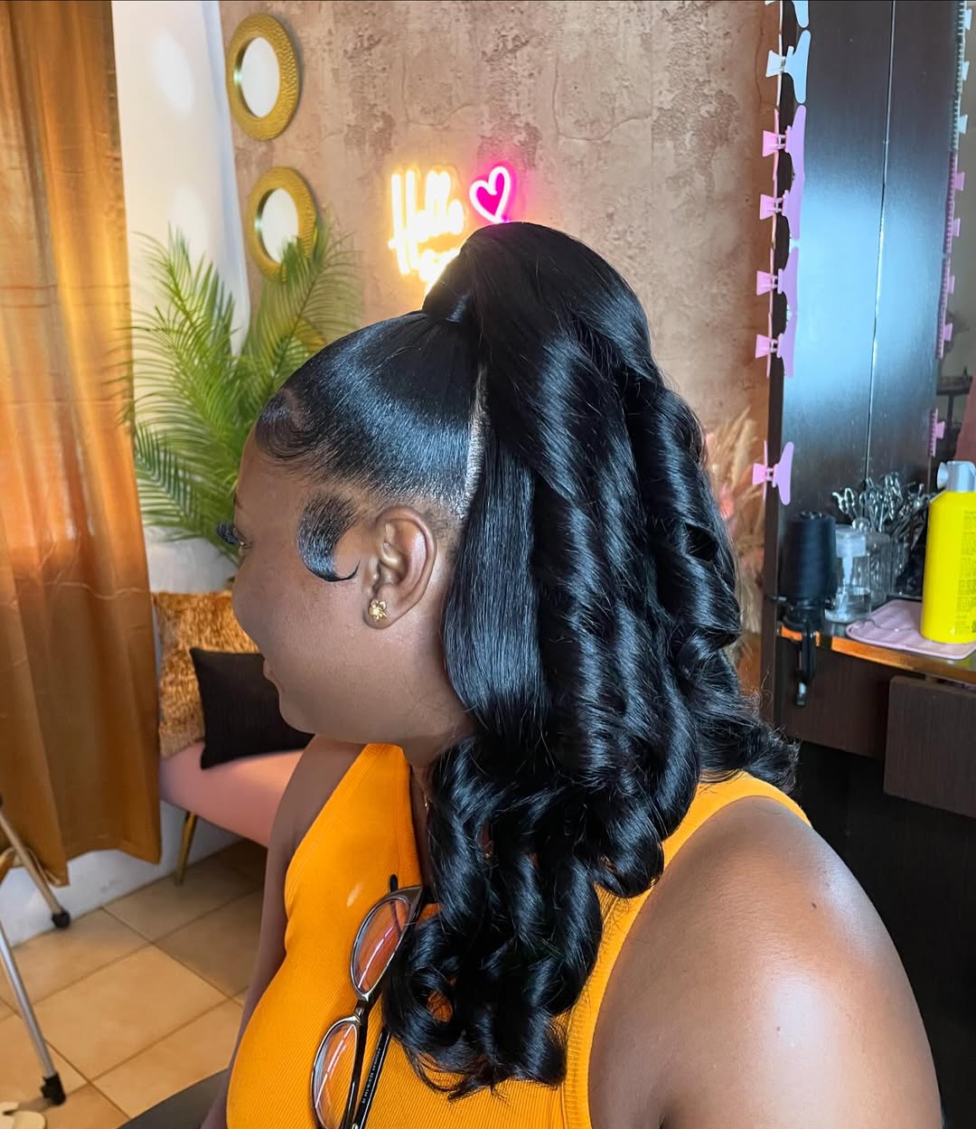 High curly invisible ponytail with styled swooped edges and voluminous black curls