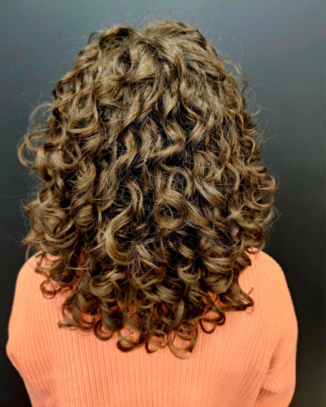 voluminous medium length brown curly perm