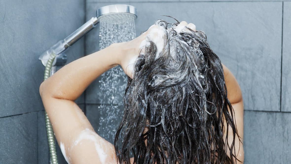 women washing hair with shampoo in washing area