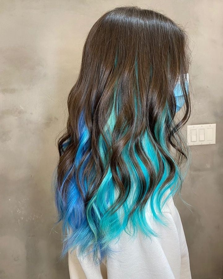 wavy brown hair with blue underneath