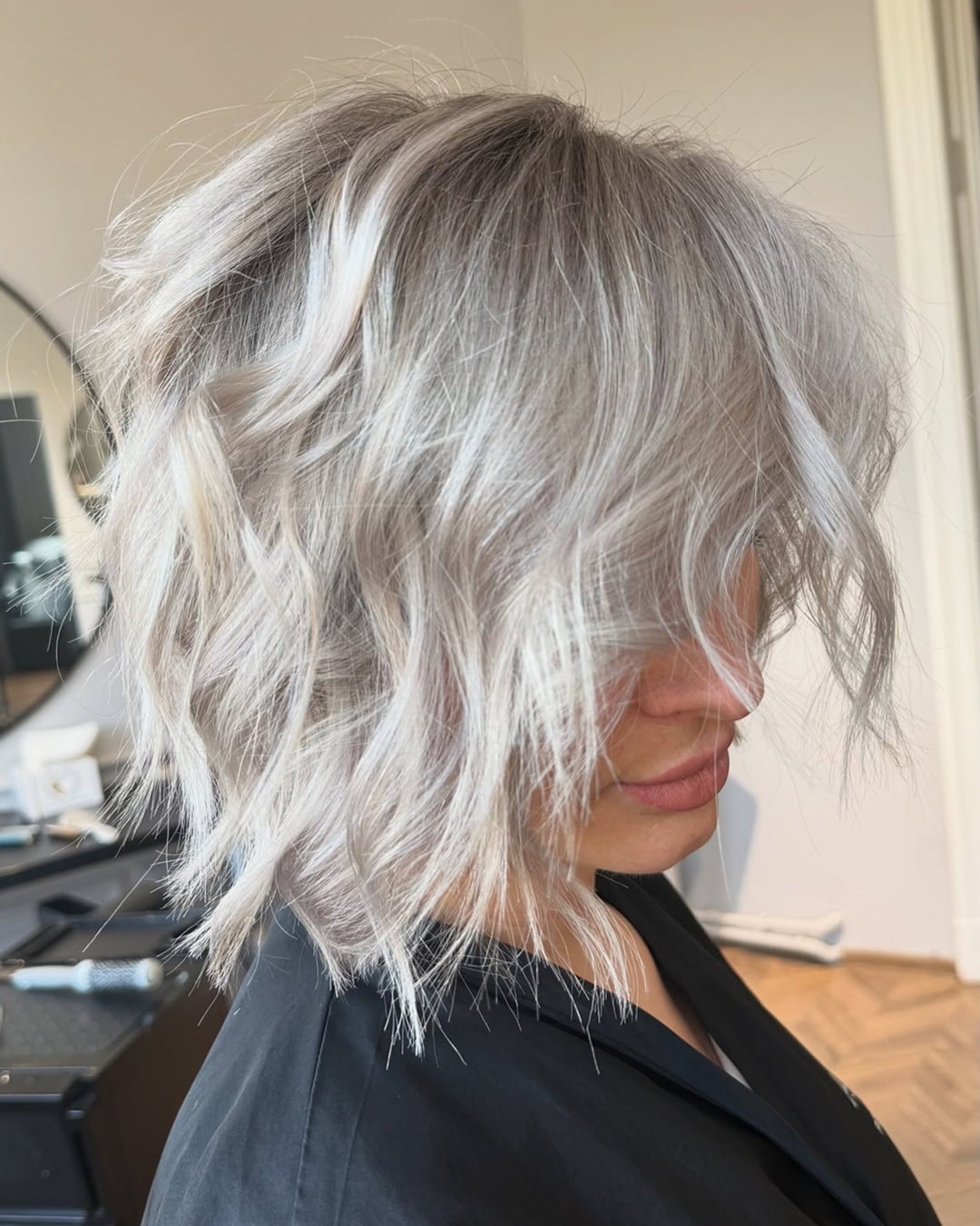 Textured wavy ice blonde choppy bob with curtain bangs