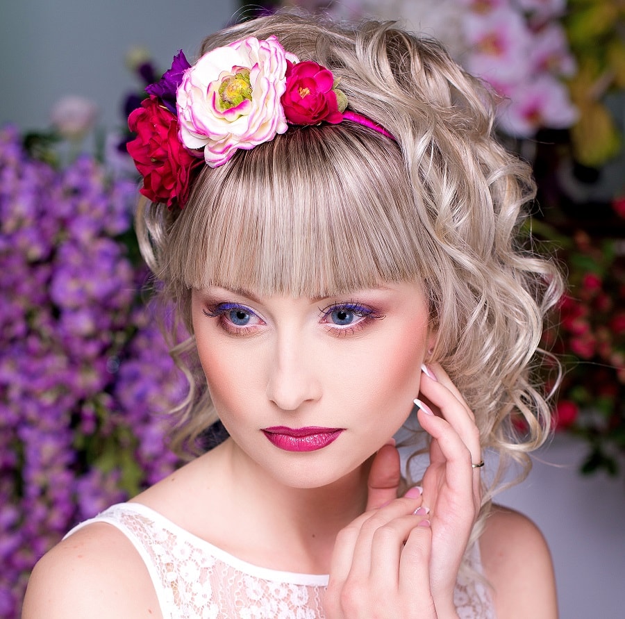 Curly hairstyle for wedding with straight bangs and headband