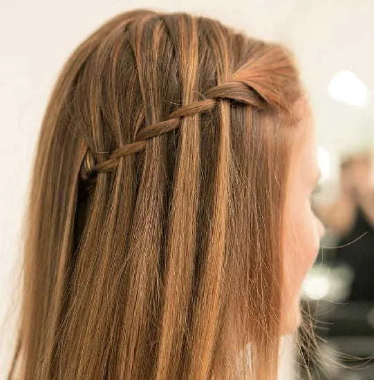 little girl's wedding hairstyle with waterfall braid