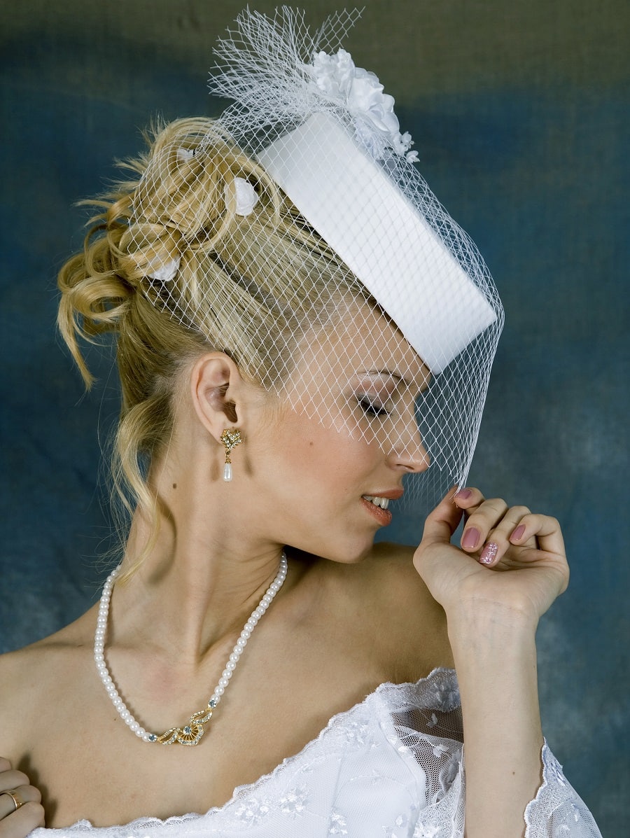 wedding updo with a hat