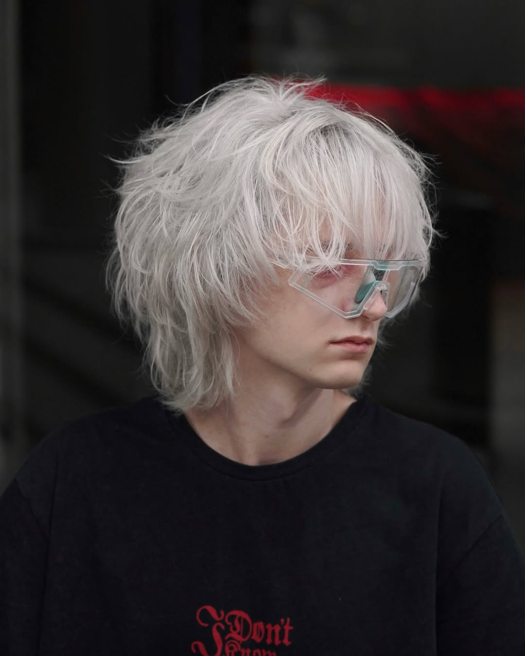 young man with a messy white shag cut and heavy brow grazing fringe