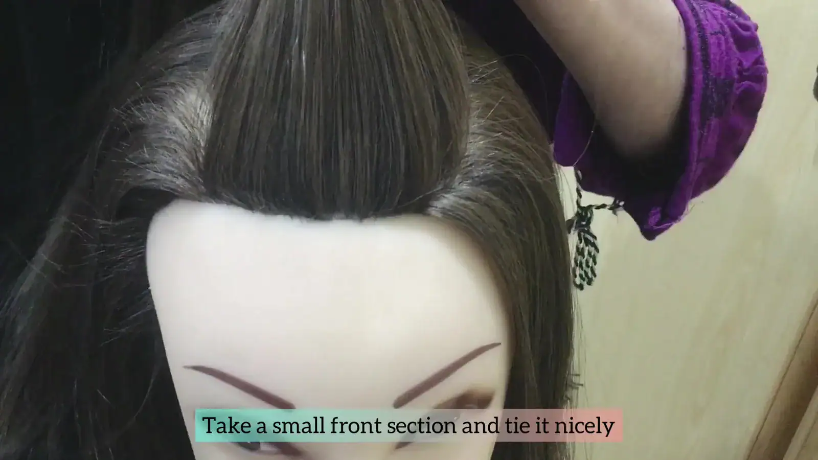 Step 1 front anchor section at the hairline secured with a mini elastic.